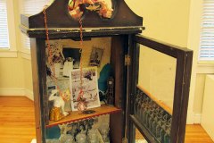 Assembled sculpture of an antique medicine cabinet and pill jars.