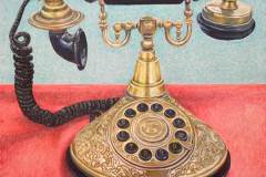 An ornate brass princess-style telephone with a round dial.