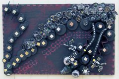 Black and magenta assemblage canvas adorned with beads.