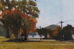 10 – Acrylic painting by J Bowers of a white house under tress turning red for fall.
