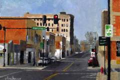 11 – Acrylic painting by J Bowers of a street scene while waiting at a red light on Gastonia's Main Street.