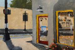 36 – Acrylic painting by J Bowers of a street scene with the entrance of a local pizza restaurant.