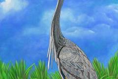 17 large crane with intricate patterned wings in a green grassy field against a bright blue sky.