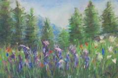 33 pine trees in the distance with red and purple flowers in the forefront of a wooded clearing