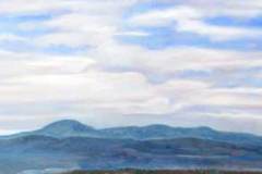 54 wide horizontal view of blue ridge mountains under a blue cloudy sky.