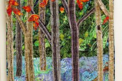 76 Textile hanging artwork of woven applique-quilt forest scene of tall trees with fall red leaves.