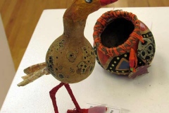 Colorful gourd sculpture of bird and nest.