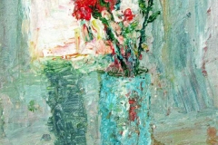 Two red flowers in a turquoise vase.