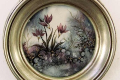 Round painting of pale magenta flowers.