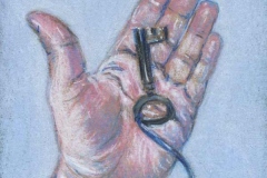 Woman’s hand holding an antique key on a blue ribbon.