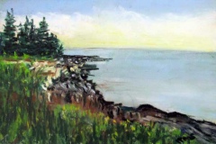 Green semi-wooded cliffside overlooking a calm blue sea under a bright sky.