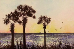 Three palmettos and seagulls overlooking an ocean sunset.