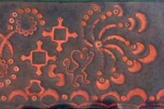 26 - red leather stamping pattern of simple flowers and geometric swirls on black leather