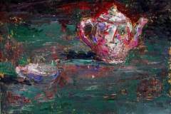 76 - magenta decorated ceramic teapot and teacup against a dark green background