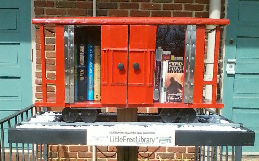 books for free little library inside miniature red caboose