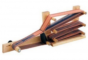 Inkle loom with thread.