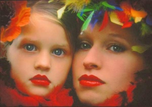 faces of a woman and girl viewed unclose surrounded by brightly colored feathers photographed by Lynne Parker.