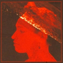 Photograph of woman in profile lit in red light by Lynne Parker.