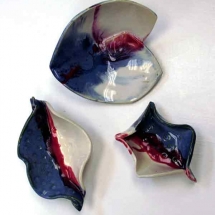 3 Blue, red, and white pottery dishes by Amelia Lenke.