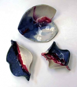 3 Blue, red, and white pottery dishes by Amelia Lenke.