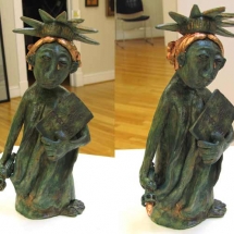 2 views of a clay sculpture of a grieving statue of liberty by artist Janet Sims.