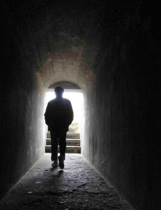 Photograph of man in dark tunnel by Alex Pietersen.