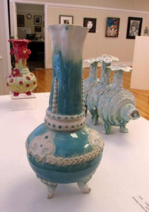 aqua marine colored vase with white fleur-de-lis decorations and scallops by artist Renee Matthews.