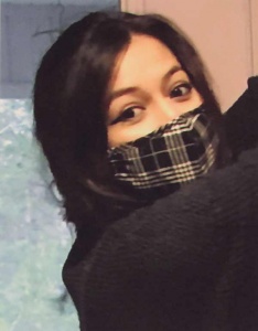 Photograph of dark haired woman in a plaid mask by Patricia Pietersen.