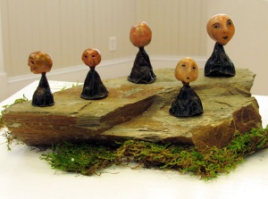 decorated plant pod figure sculptures by artist Crystal Whitesides.