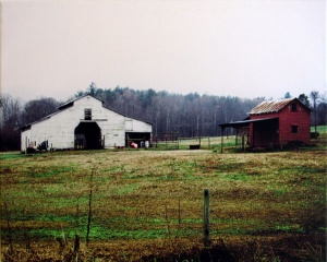 Appalachian white barn and red lean-to photographed in color by photographer Robert Webb.