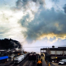 Rail yard under late afternoon skies photographed in color by photographer Robert Webb.