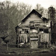 Barn of crumbling old wood photographed in black and white by photographer Robert Webb.