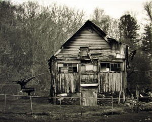 Barn of crumbling old wood photographed in black and white by photographer Robert Webb.