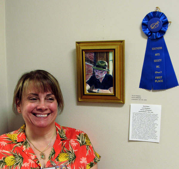 Artist Lori McAdms wins first place for her scratchboard and ink painting / drawing At the Coffeeshop”.