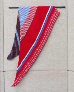 Knitted red, white, and blue striped shal by artist Beverly Sandararamen.