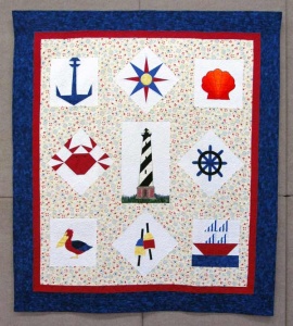 Nautical red and blue-themed patchwork quilt by artist Carol Mclaughlin.
