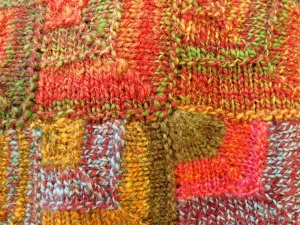 Enlarged detail of yellow, olive, and orange design on weaving by artist Chris Dunlap.