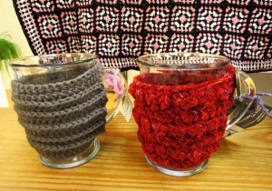 2 knitted cup holders by artst Gail Boyles.