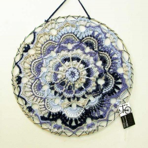 Blue and black crocheted spring flower dream catcher by artist Gail Boyles.