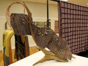 Woven stream on aged wood sculpture by artist Sue Helmken.