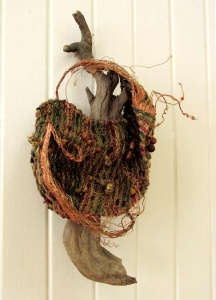 Woven textile on aged wood sculpture by artist Sue Helmken.