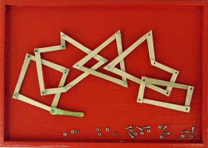 Sculpture of red box viewed from above with angular wood pieces and metal screws.