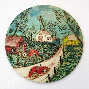 Round disk cut from tree trunk depicting a wolf’s head line drawing.