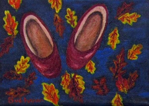 Two red shoes among falling fall leaves.