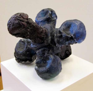 Blue and black cast iron abstract sculpture with six spherical endings.