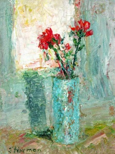 Two red flowers in a turquoise vase.