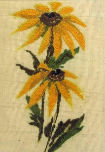 Two stitched golden black eyed Susan flowers.