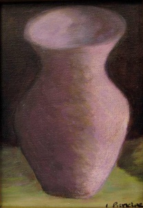 Pink vase on a green surface.