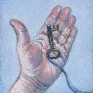 Woman’s hand holding an antique key on a blue ribbon.