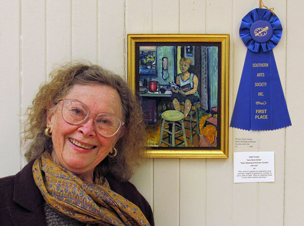 First place winner Sara Dame Setzer with her oil painting Dawn Reading at Kitchen Counter with Cat.
